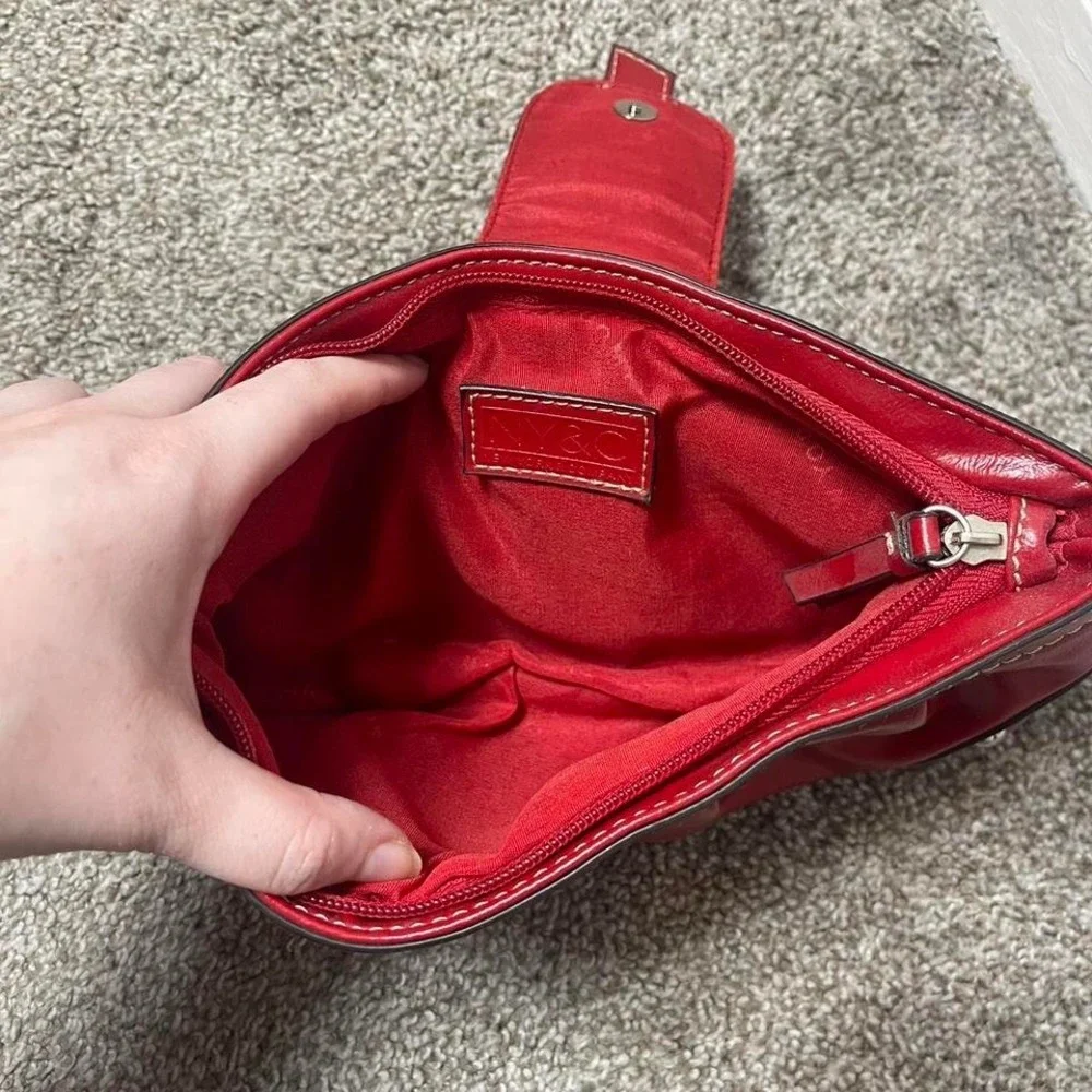 Red leather clutch handbag with silver hardware